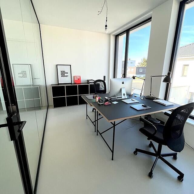 Montagmorgen in unserem verglasten Think Tank alias Arbeitszimmer. Nachdem die letzten Umzugskisten ausgepackt sind, lässt sich dort nun gut arbeiten.

/////////////////
Da Bauherr und -in unterschiedlich groß sind, haben wir einen der neu erworbenen Eiermann-Schreibtische (schwarze Linoleumplatte mit Holzfurnierschicht an der Seite, schwarzes Metallgestell) mit Aufsatz bestellt, den anderen ohne. Passend dazu haben wir uns für ein Aktenordner-Regal von tylko mit den gleichen Materialien entschieden.

/////////////////
Es fehlt noch eine Deckenlampe, aber die Baustellenleuchte setzt ihren ganz eigenen Akzent im Bauhaus-Ambiente... Und ja, aus Designgründen dürften da keine gepolsterten Bürostühle, sondern höchstens Werkstatt-alike Drehhocker mit schwarzem Gestell und Holzplatte stehen. Da wir es aber auch über mehrere Stunden bequem haben möchten, dürfen die Ikea-Stühle bleiben. Vorerst…

/////////////////
#hausbau2022 #bauherren2022 #bautagebuch #bauhausstil #flachdachhaus #architektenhaus #cubehouse #kubushaus #glaswand #glastrennwand #glaskasten #glaswall #schwarzerrahmen #blackframe #sichtbetonwand #concrete #concretewall #arbeitszimmer #büro #office #homeoffice #workspace #thinktank #m3raumsysteme #quintit #tylko #tylkoregal #eiermanntable #eiermann2 #eiermann2desk