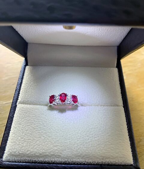 Three stone ruby ring with small diamonds