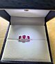 Three stone ruby ring with small diamonds