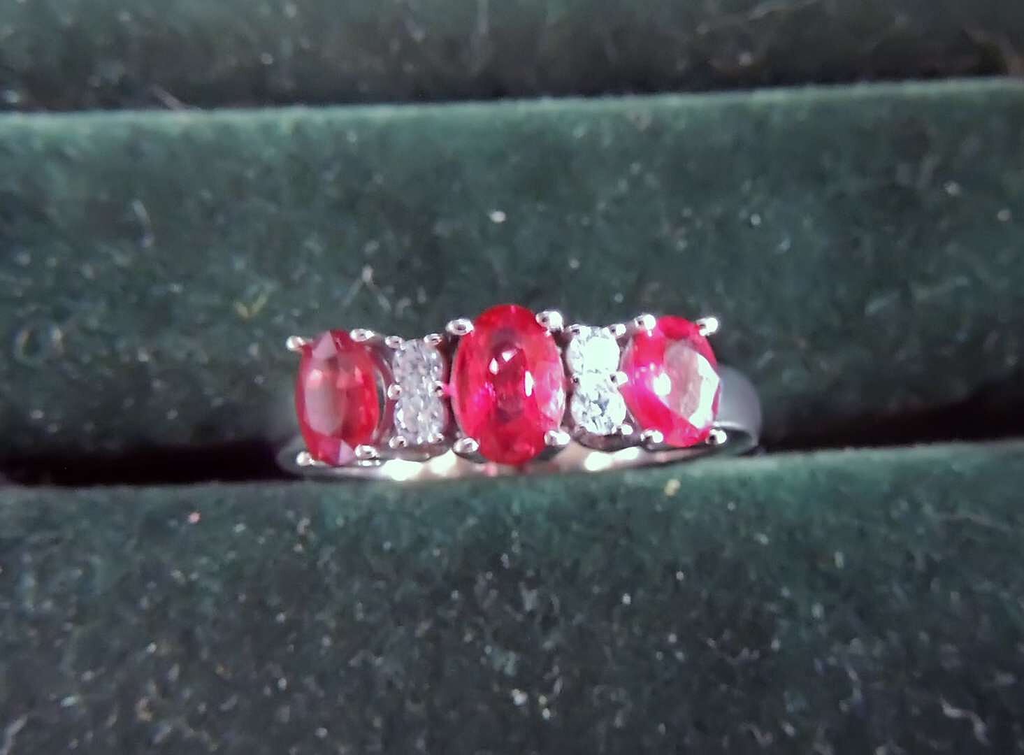 Three stone ruby ring with small diamonds