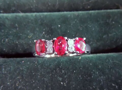 Three stone ruby ring with small diamonds