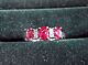 Three stone ruby ring with small diamonds