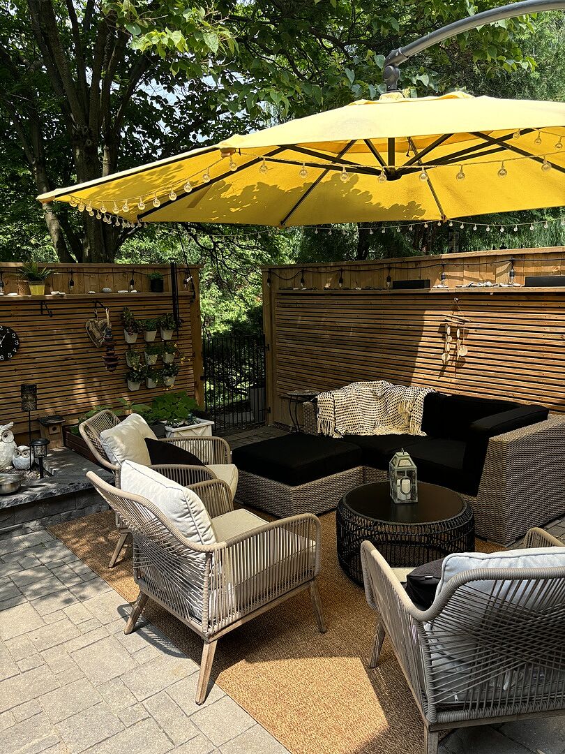Lovett Vive wicker love seat with black Sunbrella cushions, Canadian made patio furniture, in a WickerPark customer's backyard