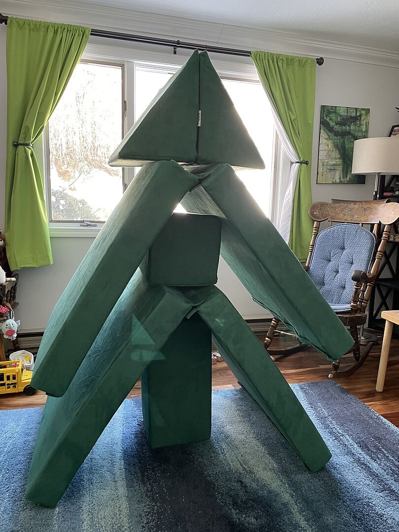 A child building with a Figgy play couch
