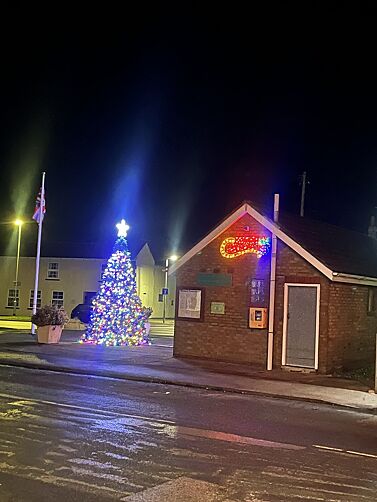 Village Christmas tree sparkling outdoors